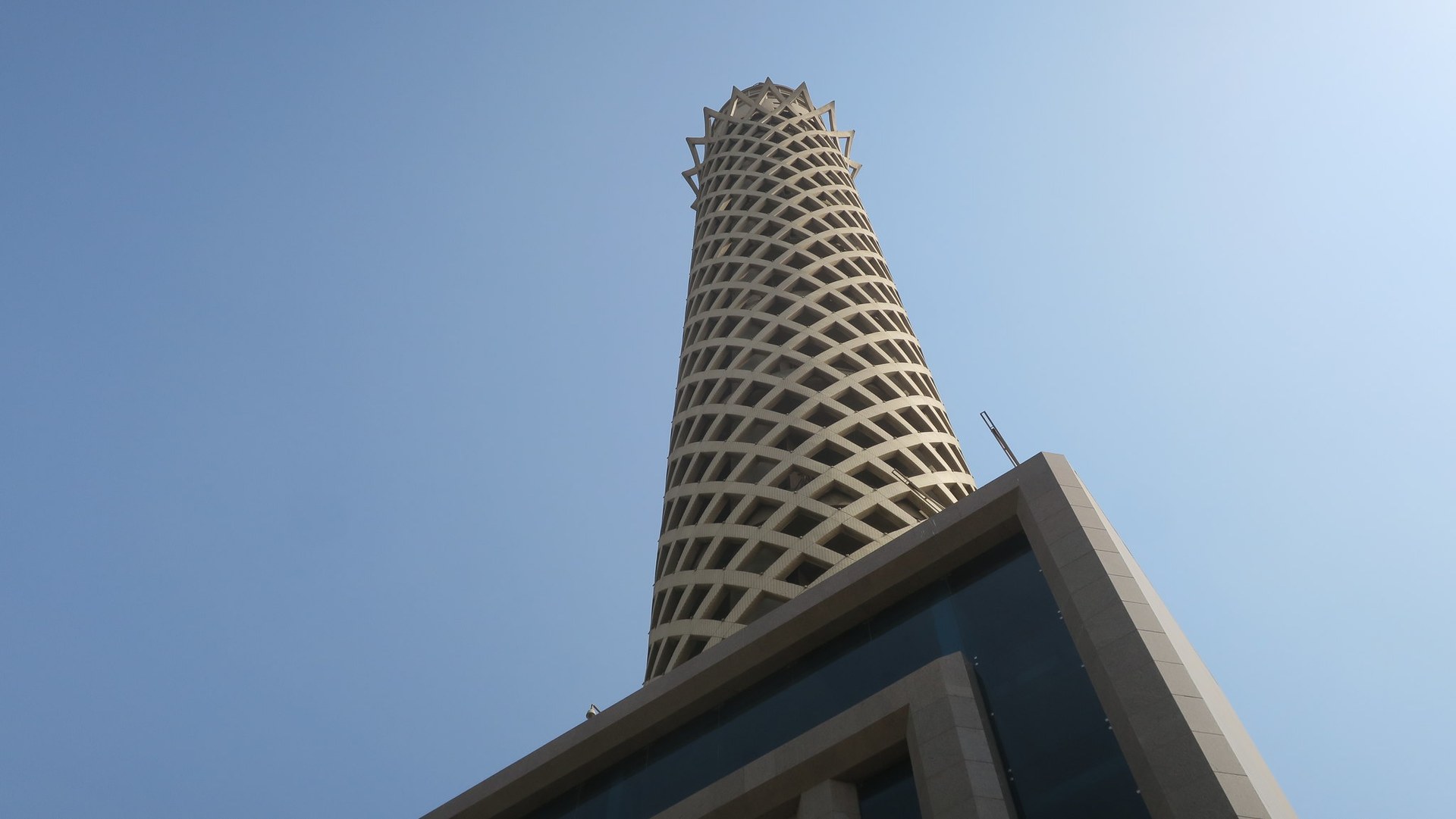 The concrete lattice of Cairo Tower against a blue sky