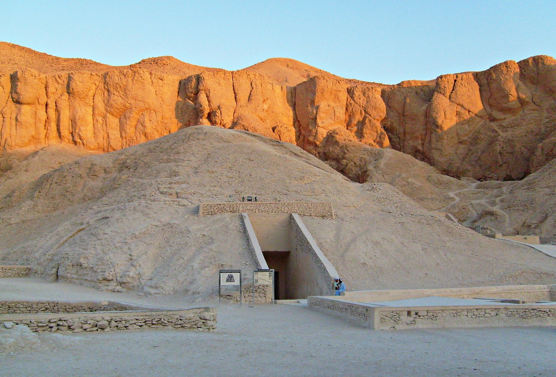 The entrance to the Tomb of Ramesses IV in the Valley of the Kings, below cliffs in the evening light