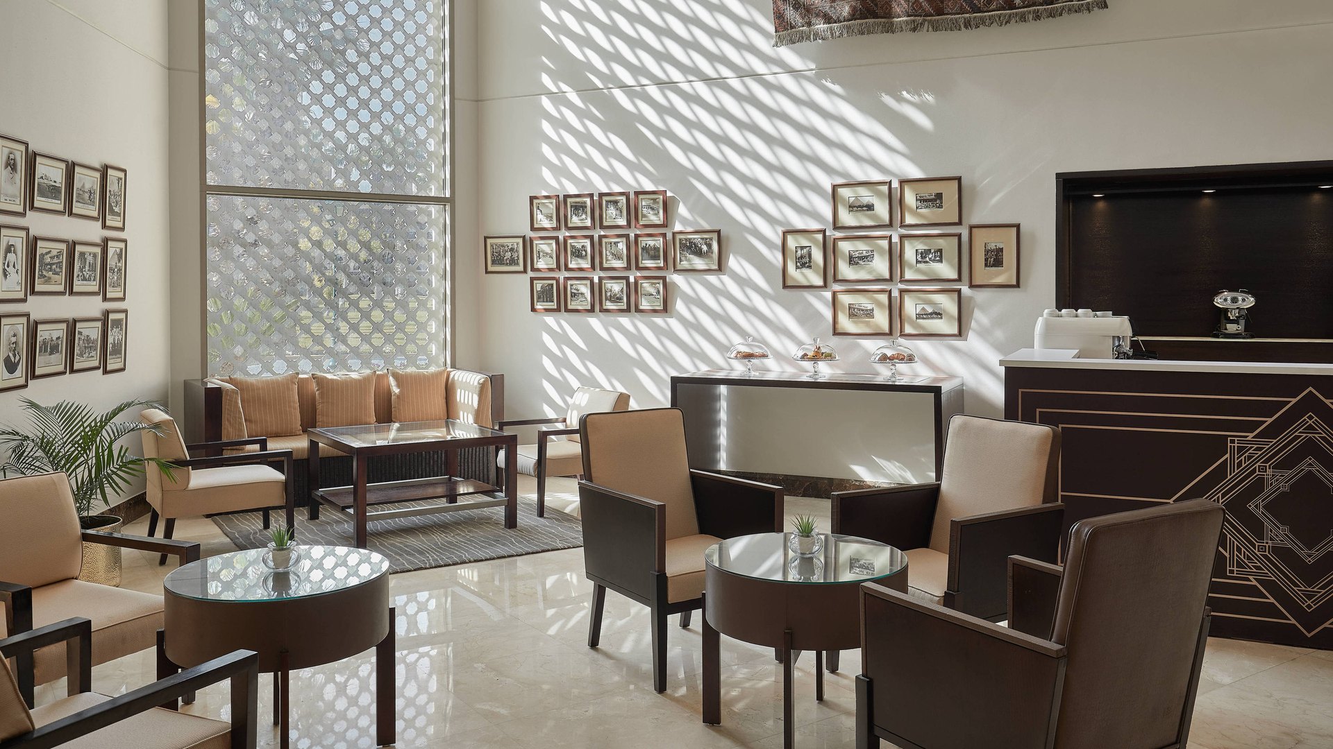 The lobby lounge of Mena House, lit through a mashrabiya screen