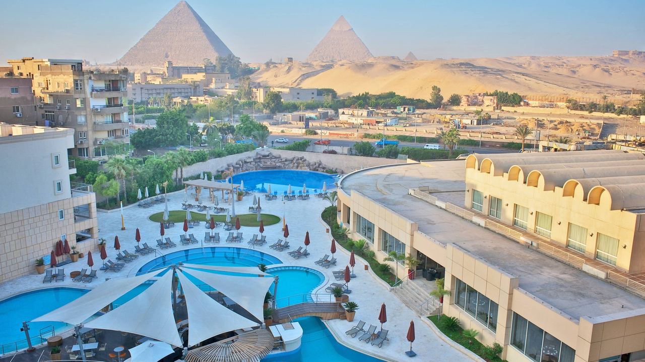Le Méridien Pyramids and its pools, with the Pyramids of Giza on the desert edge