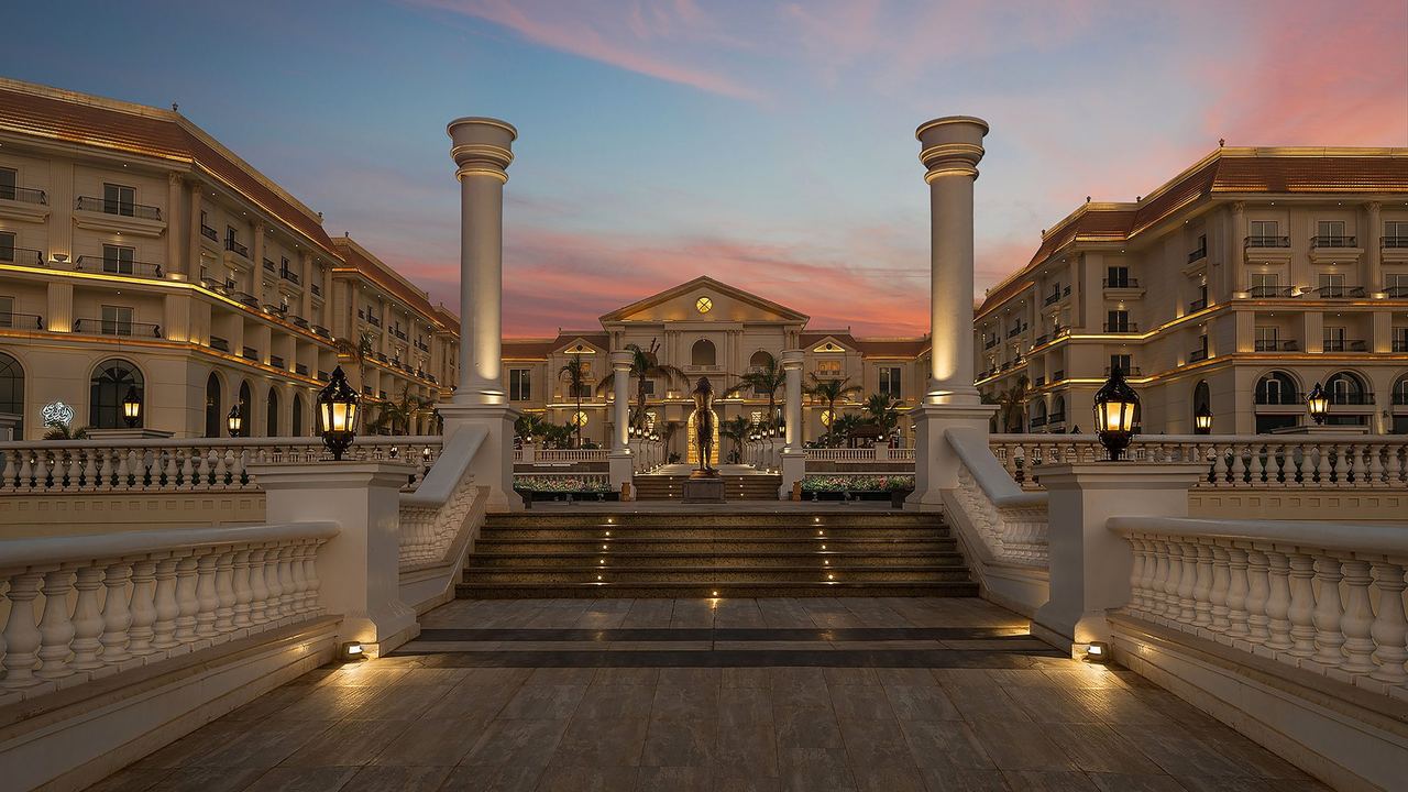 The colonnaded forecourt of The St. Regis New Capital at sunset